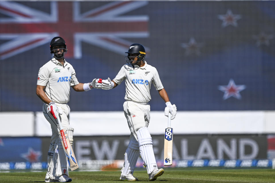 New Zealand's Rachin Ravindra, right, gestures to teammate Daryl Mitchell on day three of the second cricket test between New Zealand and Australia in Christchurch, New Zealand, Sunday, March 10, 2024. (John Davidson/Photosport via AP)