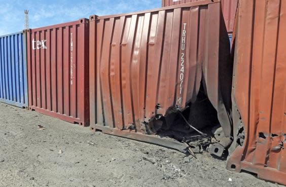 A damaged container is pictured at a port in Libya's capital Tripoli after it was hit by rocket fire (AFP via Getty Images)