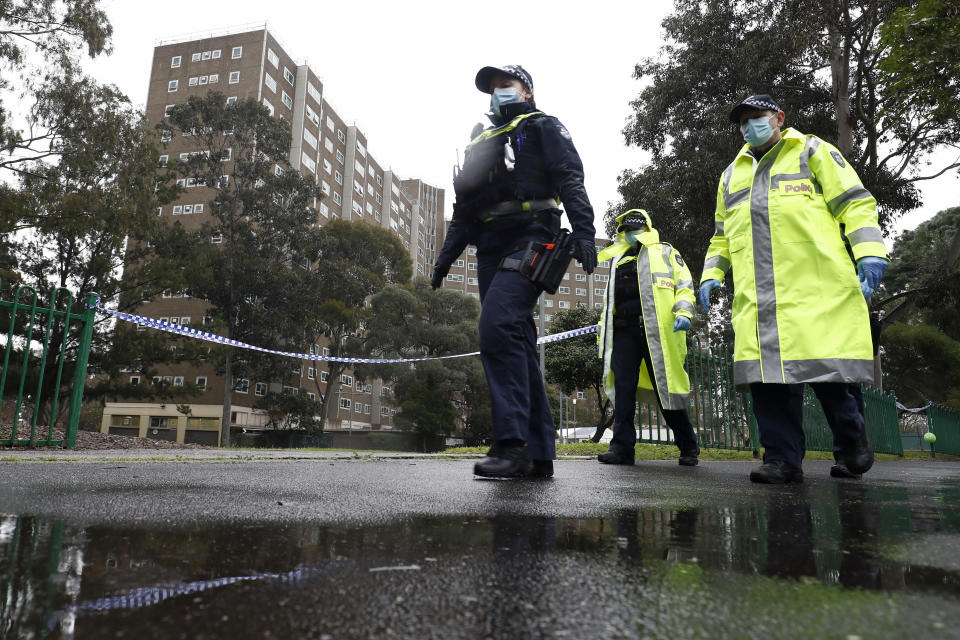 Members of the Victoria police patrol outside a public housing tower that was placed under "hard lockdown" in Melbourne on July 11, 2020. (Photo: Darrian Traynor via Getty Images)