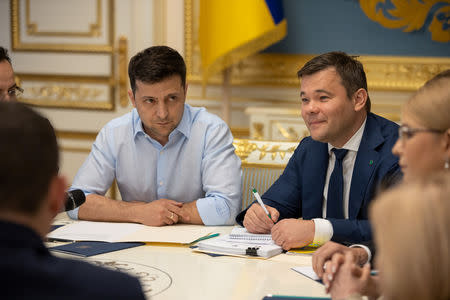 President of Ukraine Volodymyr Zelenskiy (L) and his lawyer and adviser Andriy Bogdan (R) attend a meeting with lawmakers in Kiev, Ukraine May 21, 2019. Ukrainian Presidential Press Service/Handout via REUTERS