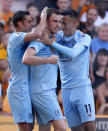 Burnley's Ashley Barnes, center, celebrates scoring against Wolverhampton Wanderers during the English Premier League soccer match Between Burnley and Wolverhampton Wanderers at Molineux, Wolverhampton, England, Sunday Aug. 25, 2019. (Darren Staples/PA via AP)