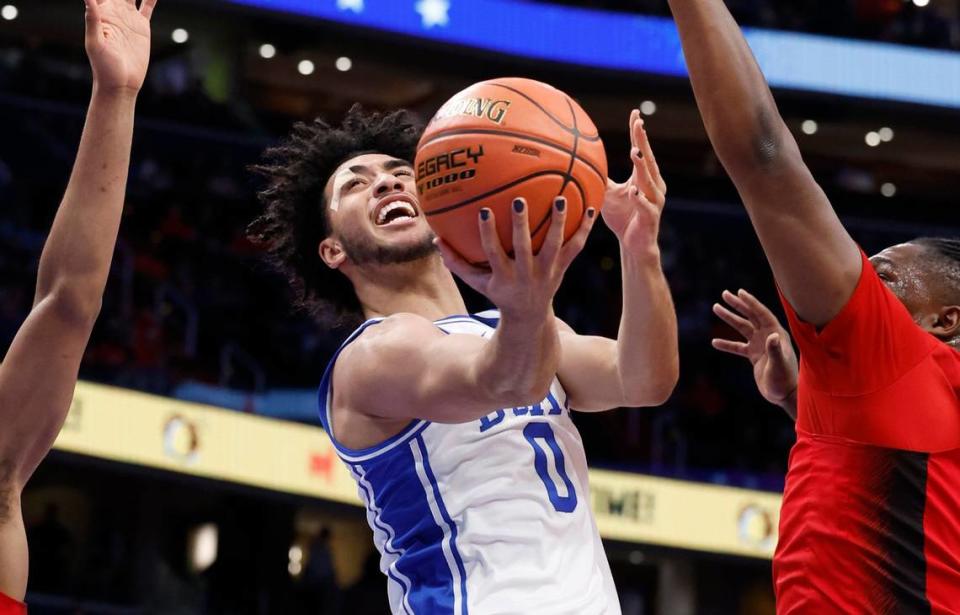 Duke’s Jared McCain (0) shoots as N.C. State’s DJ Burns Jr. (30) defends during the first half of N.C. State’s game against Duke in the quarterfinal round of the 2024 ACC Men’s Basketball Tournament at Capital One Arena in Washington, D.C., Thursday, March 14, 2024. Ethan Hyman/ehyman@newsobserver.com