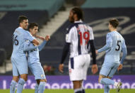 Manchester City's Joao Cancelo, second left, celebrates with Manchester City's Rodrigo, left, after scoring his side's second goal during the English Premier League soccer match between West Bromwich Albion and Manchester City at the Hawthorns stadium in West Bromwich, England, Tuesday, Jan. 26, 2021. (Nick Potts/Pool via AP)