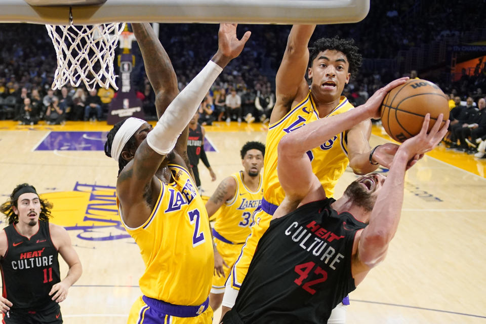Miami Heat forward Kevin Love (42) shoots as Los Angeles Lakers forward Jarred Vanderbilt (2) and guard Max Christie (10) defends during the first half of an NBA basketball game Wednesday, Jan. 3, 2024, in Los Angeles. (AP Photo/Mark J. Terrill)