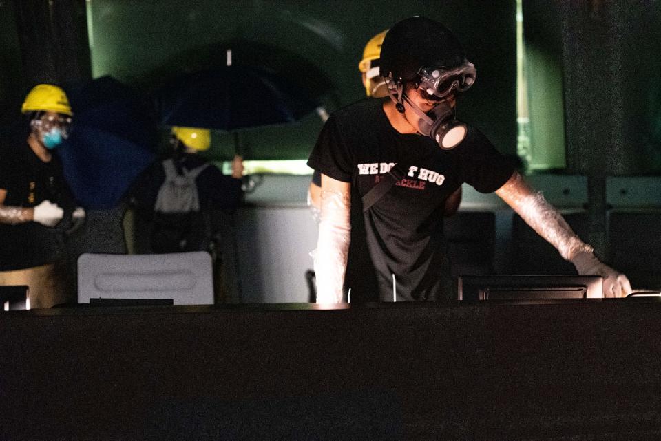 Protesters break into the chamber of Legislative Council in Hong Kong on July 1, 2019, on the 22nd anniversary of the city's handover from Britain to China. - Anti-government protesters stormed Hong Kong's parliament building late on July 1 after successfully smashing their way through reinforced glass windows and prizing open metal shutters that were blocking their way. (Photo by Philip FONG / AFP)        (Photo credit should read PHILIP FONG/AFP/Getty Images)