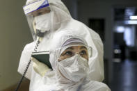 Medical staff in protective suits work at an ICU in Infectious Hospital No. 2 in Nizhny Novgorod, Russia, on Wednesday, Oct. 20, 2021. The low vaccination rate in Russia, where only about a third of the population is fully vaccinated, is causing concern as the country suffers a sharp rise in cases, setting records for infections and deaths nearly every day this month. (AP Photo/Roman Yarovitcyn)