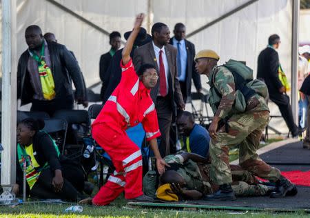 Medics attend to people injured in an explosion during a rally by Zimbabwean President Emmerson Mnangagwa in Bulawayo, Zimbabwe June 23, 2018. Tafadzwa Ufumeli/via REUTERS