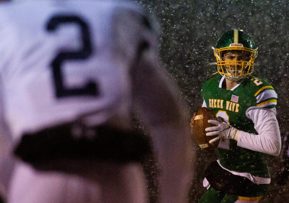 Newark Catholic senior quarterback Cole Canter looks for a receiver against Warren John F. Kennedy last Saturday, during the Division VII state semifinals at Marlington Stadium.