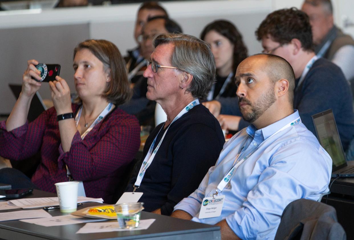 Amanda Thomas, left, Harold Tobin and Diego Melgar Moctezuma listen to presenters during a symposium about the Cascadia Subduction Zone held at the University of Oregon.