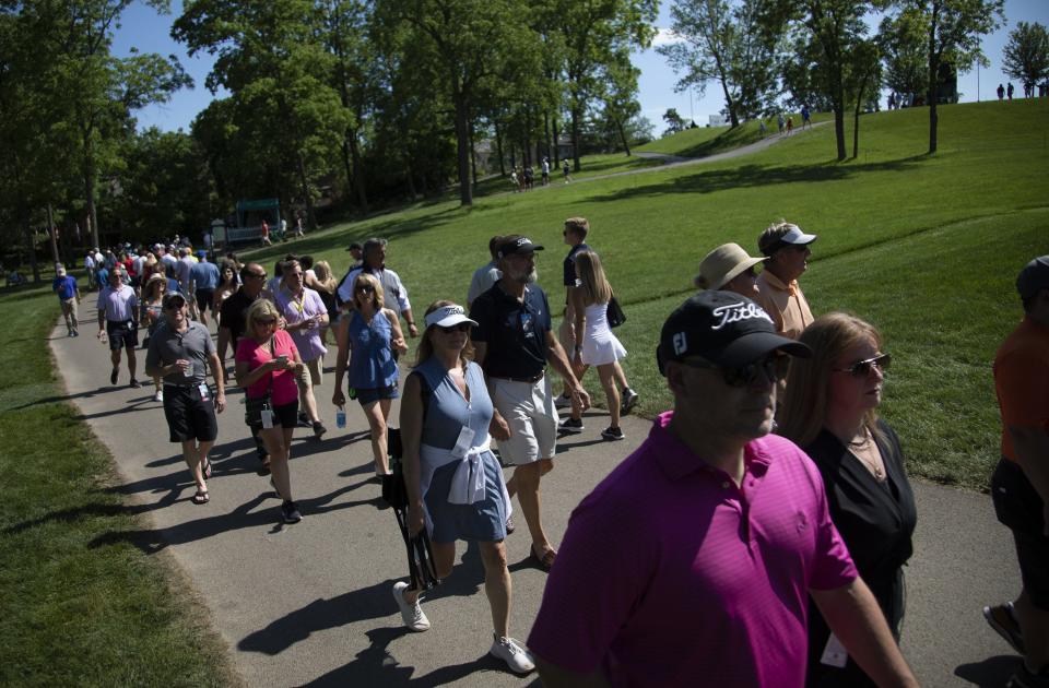 Fans walk along the 18th hole Friday during the second round of the Memorial Tournament at Muirfield Village Golf Club in Dublin.