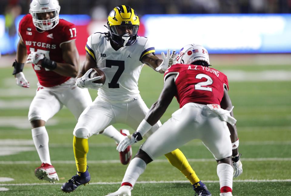 Michigan running back Donovan Edwards rushes against Rutgers defensive back Avery Young during the first half on Saturday, Nov. 5, 2022 in Piscataway, New Jersey.