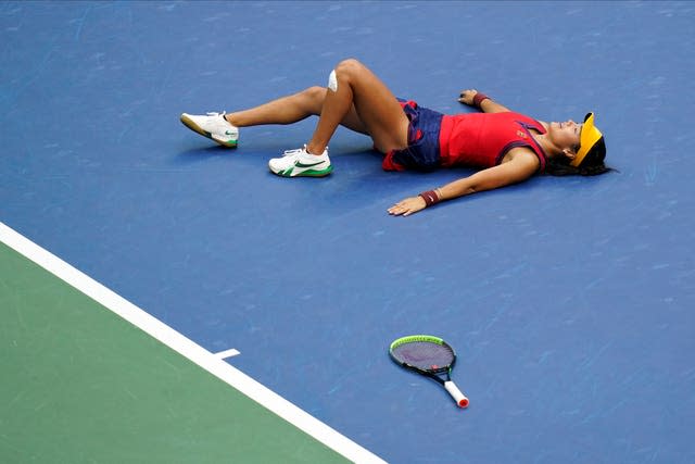 Emma Raducanu lies on the court after beating Leylah Fernandez