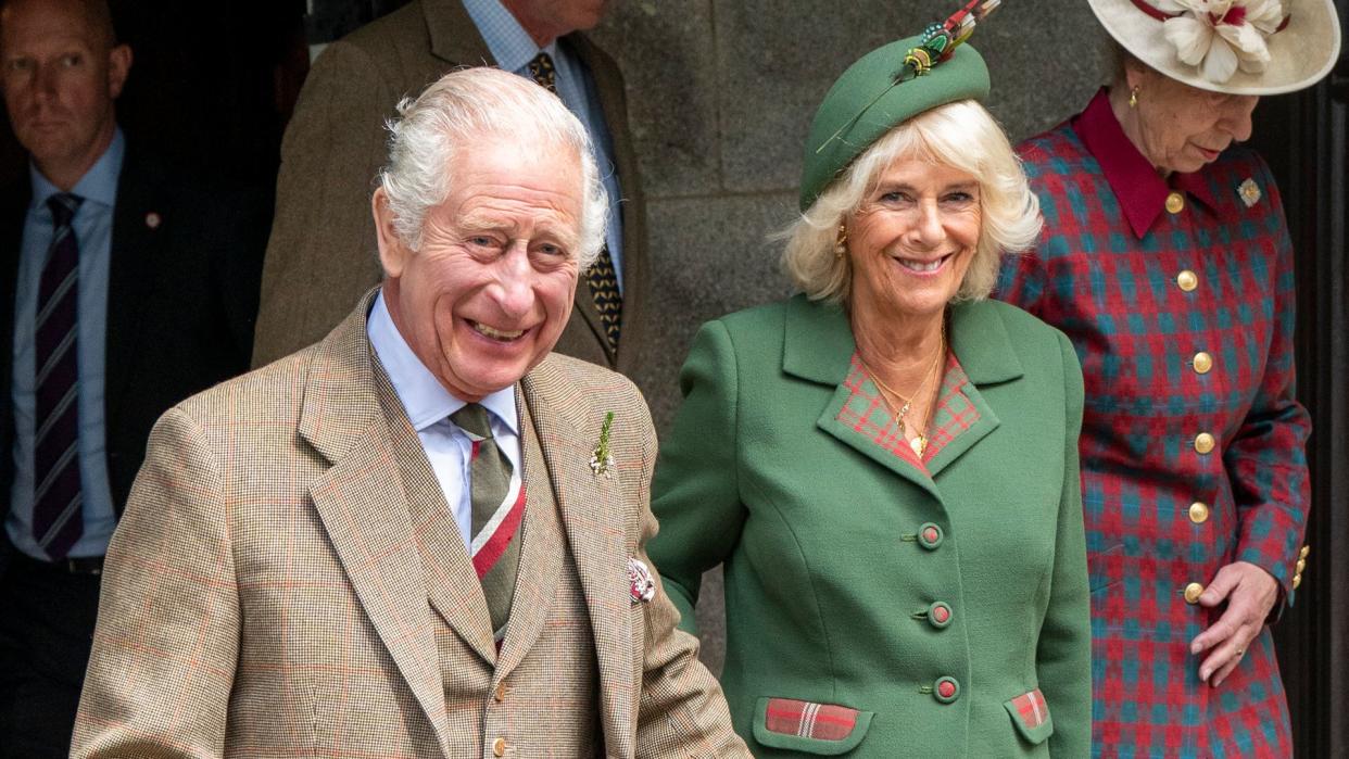 The King and Queen smiling as they leave church in Balmoral