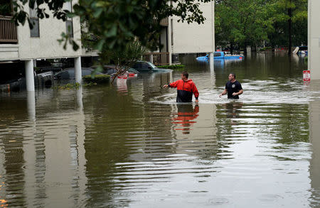 FILE PHOTO: Men look for people wanting to be evacuated from the Hurricane Harvey floodwaters in Dickinson, Texas, U.S., August 28, 2017. REUTERS/Rick Wilking/File Photo