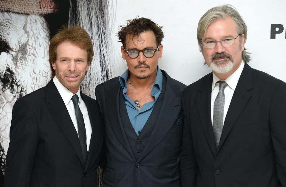 (left to right) Jerry Bruckheimer, Johnny Depp and Gore Verbinski arriving at the UK Premiere of The Lone Ranger, at the Odeon West End cinema in London.   (Photo by Dominic Lipinski/PA Images via Getty Images)