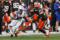 Cleveland Browns defensive back Ronnie Harrison, right, intercepts the ball ahead of Indianapolis Colts wide receiver T.Y. Hilton, left, during the second half of an NFL football game, Sunday, Oct. 11, 2020, in Cleveland. Harrison returned the ball for a 47-yard touchdown on the play. (AP Photo/Ron Schwane)