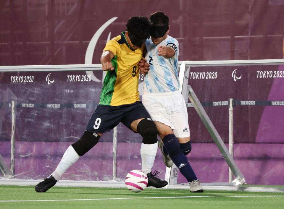 Tiago da Silva of Brazil in action with Angel Deldo Garcia of Argentina in the football five-a-side final.