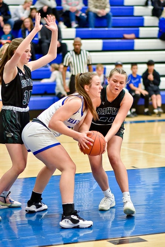 Woodward-Granger's Grace Deputy looks to grab the ball while Addie Lego helps defend a Van Meter player on Friday, Feb. 3, 2023.