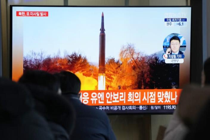 People watch a TV showing a file image of North Korea&#39;s missile launch during a news program at the Seoul Railway Station in Seoul, South Korea, Tuesday, Jan. 11, 2022. North Korea on Tuesday fired what appeared to be a ballistic missile into its eastern sea, its second weapons launch in a week, the militaries of South Korea and Japan said. The Korean letters read &quot;UN Security Council meeting.&quot; (AP Photo/Ahn Young-joon)