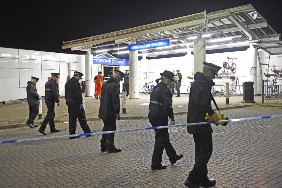 Police searching outside Hillingdon underground station in London, where a murder investigation has been launched after a man was stabbed to death.