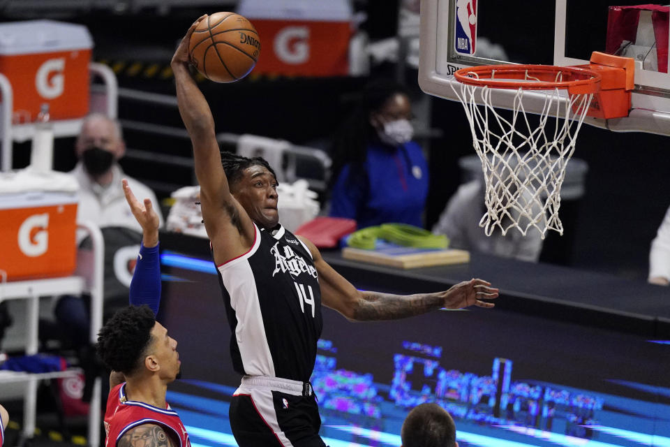 Los Angeles Clippers guard Terance Mann, right, goes up for a dunk as Philadelphia 76ers forward Danny Green defends during the second half of an NBA basketball game Saturday, March 27, 2021, in Los Angeles. The Clippers won 122-112. (AP Photo/Mark J. Terrill)