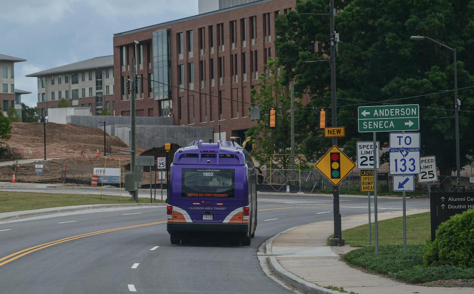 A Clemson Area Transit bus, CATbus, rides along S.C. 93 through a mostly empty campus.