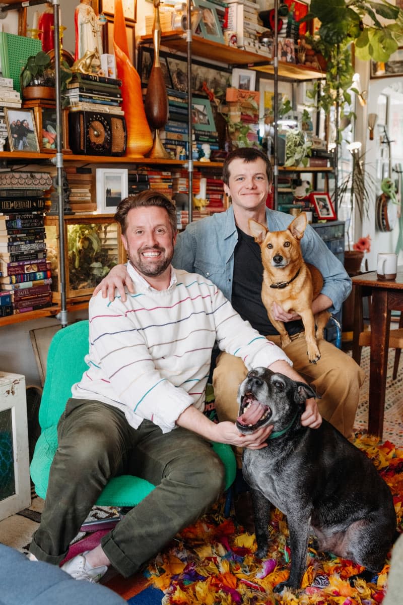 Dwellers pose with their pets in their living room.