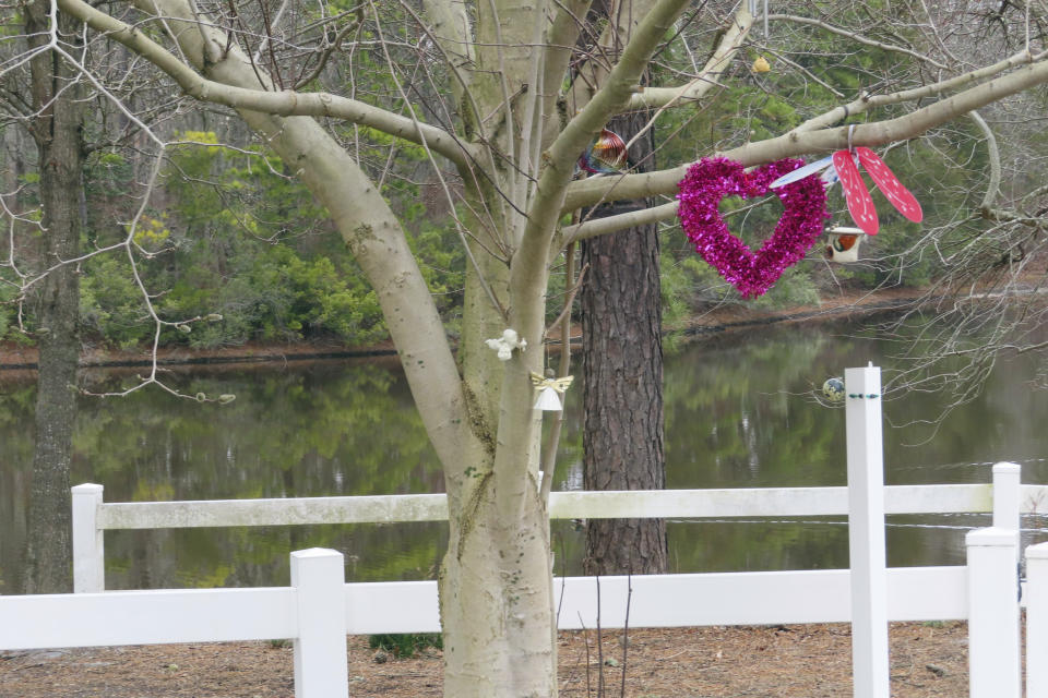 A heart hangs on a tree next to the Toms River in Toms River, N.J. on Feb. 21, 2023. Many residents of Toms River, where the former Ciba-Geigy chemical plant dumped toxic waste into the Toms River and directly onto the ground, oppose a settlement with the site's current owner, BASF Corp. to restore natural resources at the site as inadequate and ill-advised. (AP Photo/Wayne Parry)