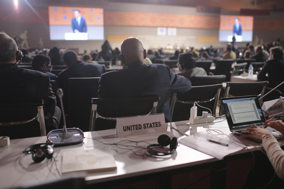 The empty seat of the US representative is seen during the opening session of a UN Migration Conference in Marrakech, Morocco, Monday, Dec.10, 2018. Top U.N. officials and government leaders from about 150 countries are uniting around an agreement on migration, while finding themselves on the defensive about the non-binding deal amid criticism and a walkout from the United States and some other countries. (AP Photo/Mosa'ab Elshamy)