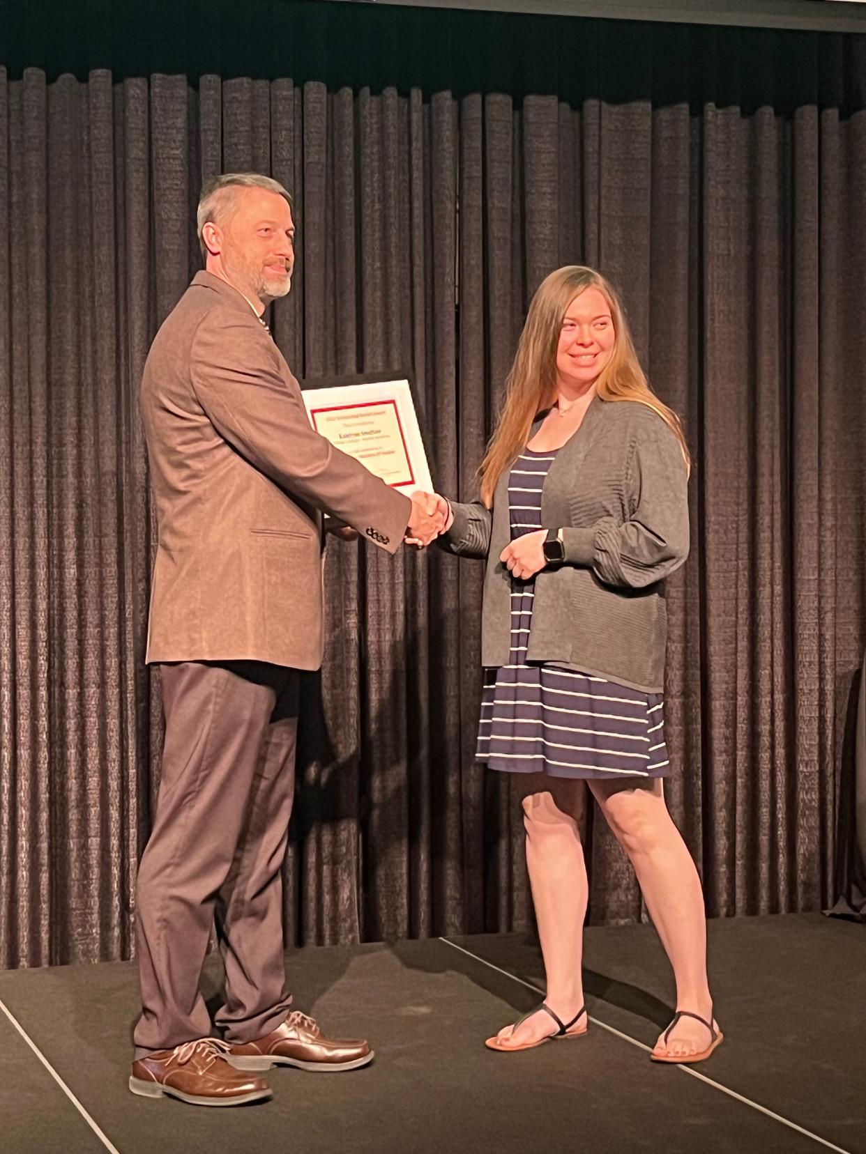 Katelynn Smeltzer receives an Outstanding Student certificate from Dr. Andy Michel, director of The Ohio State University College of Food, Agricultural, and Environmental Sciences, Wooster campus.