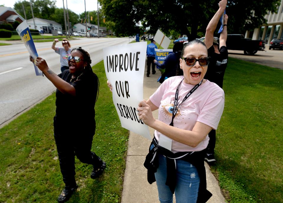 Postal worker Tamar Allison of Springfield, right, pickets with other postal workers in front of the post office at 2105 E. Cook Street Friday, May 3, 2024.