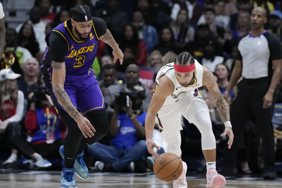 New Orleans Pelicans guard Jose Alvarado steals the ball from Los Angeles Lakers forward Anthony Davis (3) in the first half of an NBA basketball game in New Orleans, Sunday, Dec. 31, 2023. (AP Photo/Gerald Herbert)
