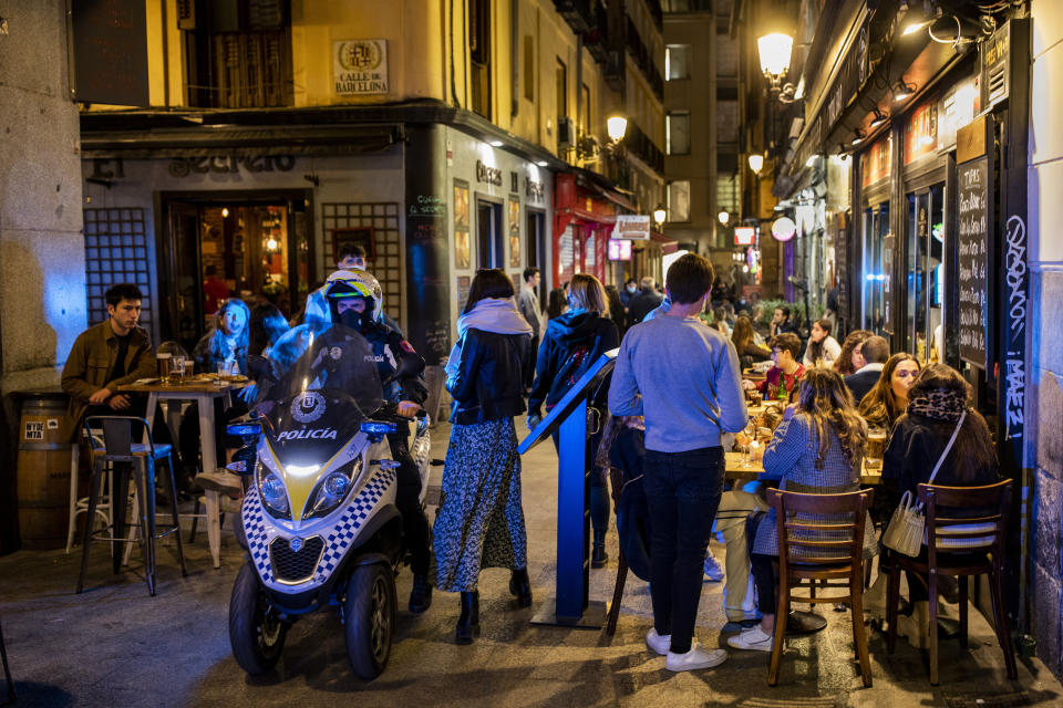 Policeman patrols in downtown Madrid, Spain, Friday, March 26, 2021. With its policy of open bars and restaurants — indoors and outdoors — and by keeping museums and theaters running even when outbreaks have strained hospitals, Madrid has built a reputation as an oasis of fun in Europe’s desert of restrictions. Other Spanish regions have a stricter approach to entertainment. Even sunny coastal resorts offer a limited range of options for the few visitors that started to arrive, coinciding with Easter week, amid a set of contradictory European travel rules. (AP Photo/Bernat Armangue)