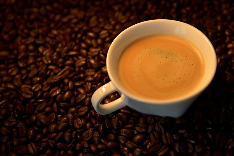 FILE PHOTO: An illustration picture shows a coffee cup and roasted coffee beans
