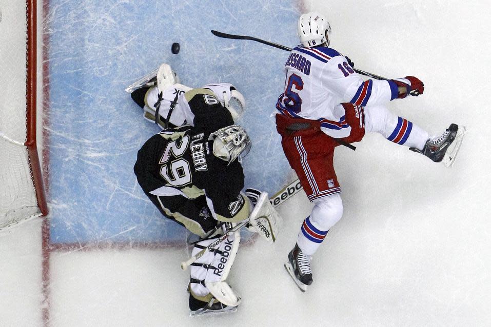 New York Rangers' Derick Brassard (16) backhands a shot past Pittsburgh Penguins goalie Marc-Andre Fleury (29) in the first period of Game 5 of a second-round NHL playoff hockey series in Pittsburgh, Friday, May 9, 2014. The Rangers won 5-1. (AP Photo/Gene J. Puskar)