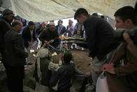 Afghan men bury a victim of bombings on Saturday near a school, west of Kabul, Afghanistan, Sunday, May 9, 2021. The Interior Ministry said the death toll in the horrific bombing at the entrance to a girls' school in the Afghan capital has soared to some 50 people, many of them pupils between 11 and 15 years old, and the number of wounded in Saturday's attack has also climbed to more than 100. (AP Photo/Mariam Zuhaib)