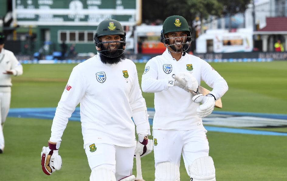 South Africa's Hashim Amla, left, and JP Duminy walk off after their team defeated New Zealand by 8 wickets during the second cricket test at the Basin Reserve in Wellington, New Zealand, Saturday, March 18, 2017. (Ross Setford/SNPA via AP)