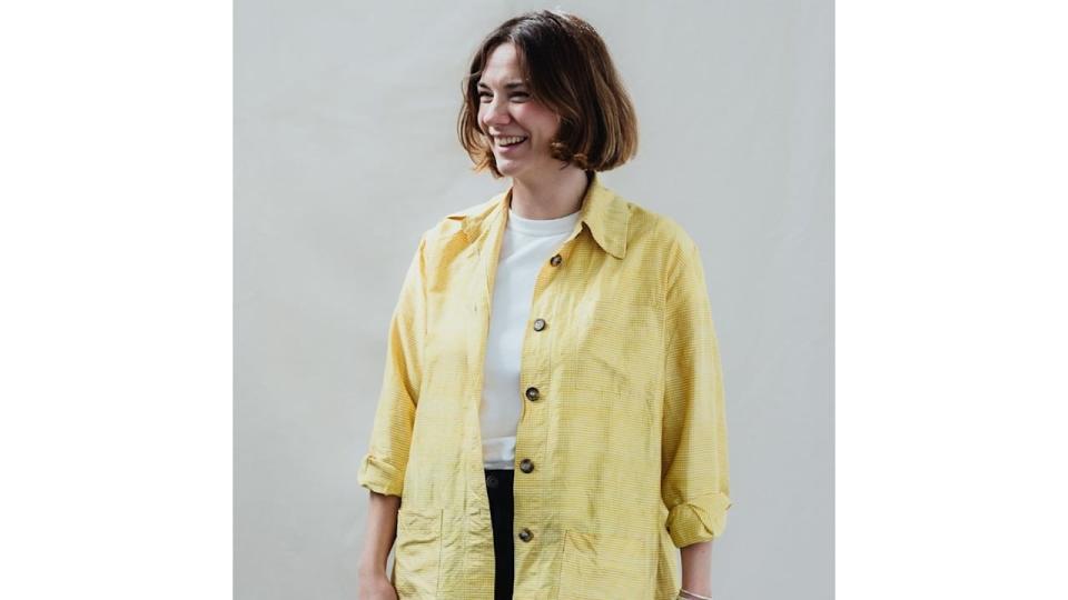 A woman in a yellow shirt and trousers