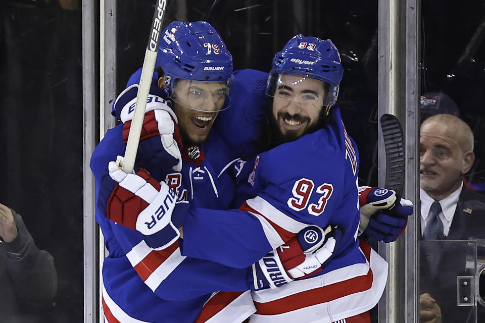 New York Rangers defenseman K'Andre Miller (79) is congratulated by Mika Zibanejad after scoring a goal against the Washington Capitals during the third period of an NHL hockey game Wednesday, Dec. 27, 2023, in New York. (AP Photo/Adam Hunger)