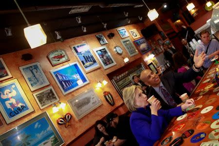 Democratic U.S. presidential candidate Hillary Clinton (L) has a coffee with New Jersey Senator Cory Booker at Omar's Cafe in Newark, New Jersey, U.S., June 1, 2016. REUTERS/Adrees Latif