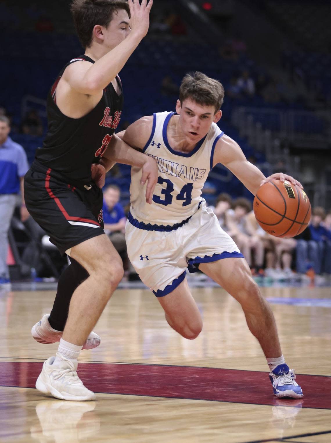 Lipan’s Tate Branson dribbles around a New Home defender in a Class 2A state semifinal on Friday, March 10, 2023 at the Alamodome in San Antonio, Texas