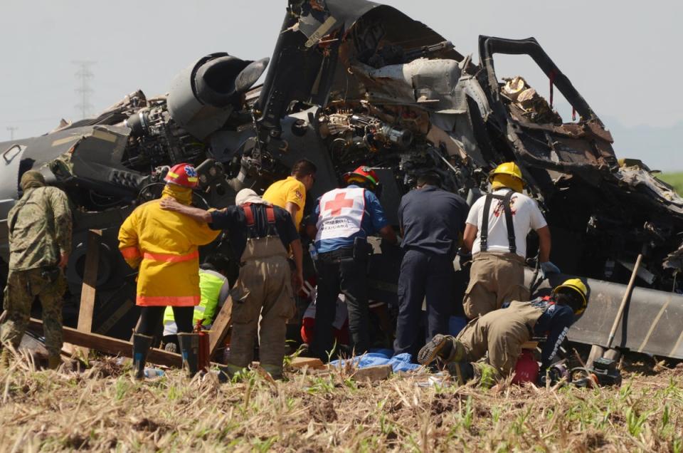 Emergency services work to retrieve dead from navy Blackhawk helicopter (AP)