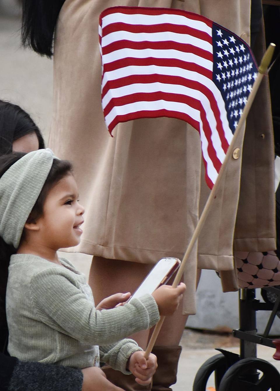 Jianette Camacho, 4, of Fall River, waves the flag during the Fall River Veterans Day Parade in 2022.