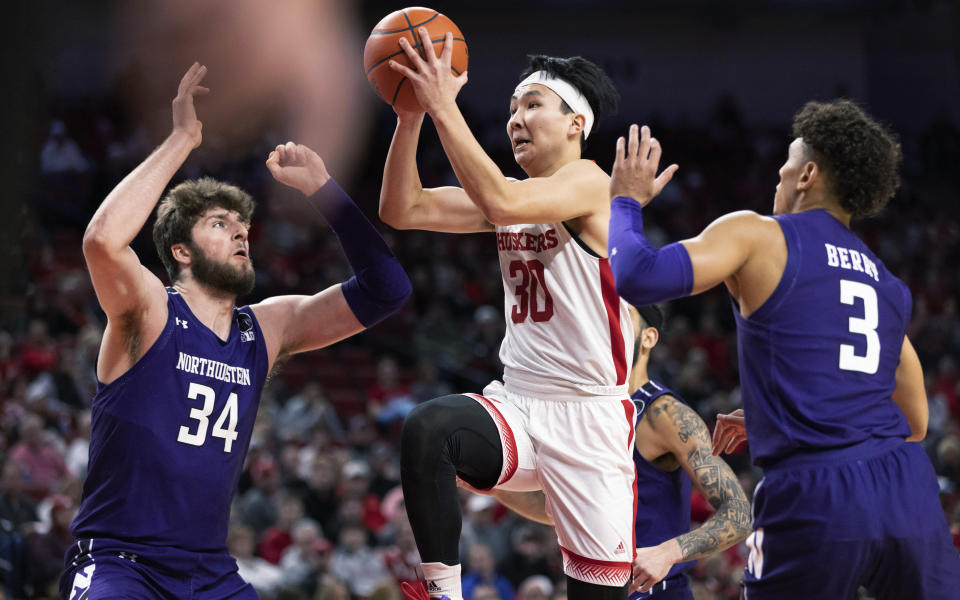 Nebraska's Keisei Tominaga (30) shoots against Northwestern's Matthew Nicholson (34) and Ty Berry (3) during the first half of an NCAA college basketball game Wednesday, Jan. 25, 2023, in Lincoln, Neb. (AP Photo/Rebecca S. Gratz)