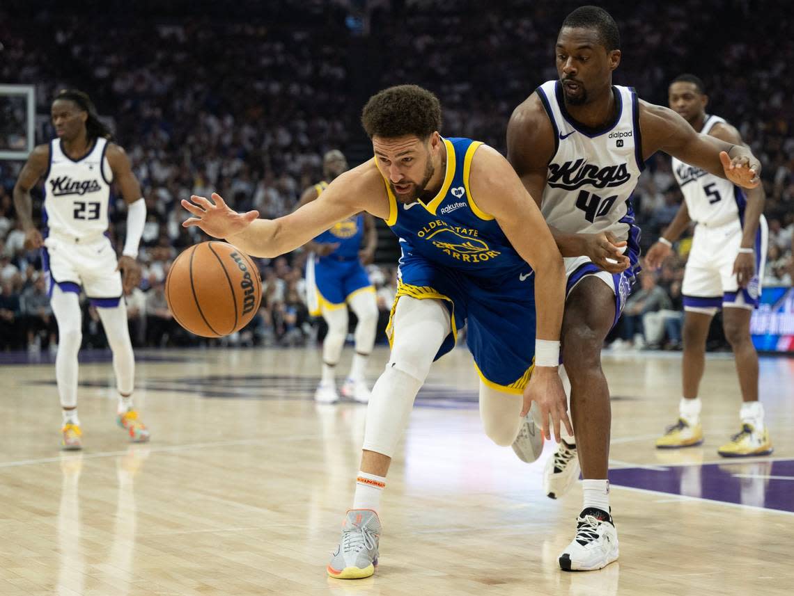 Golden State Warriors guard Klay Thompson (11) is defended by Sacramento Kings forward Harrison Barnes (40) during an NBA play-in game at Golden 1 Center on Tuesday.