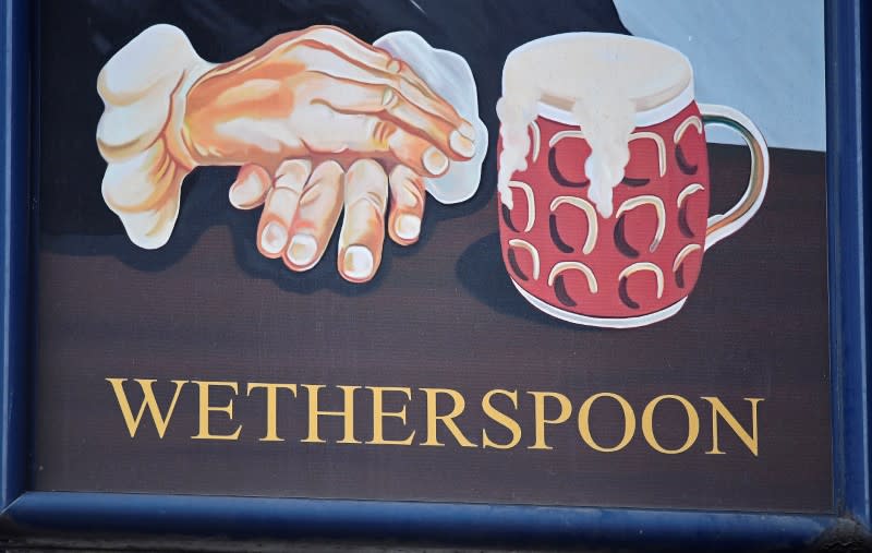 FILE PHOTO: A Wetherspoon's logo is seen at a pub in central London, Britain