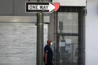 A man walks past closed stores on the first day of the reopening of some businesses in Los Angeles, as the global outbreak of the coronavirus disease (COVID-19) continues, in Los Angeles