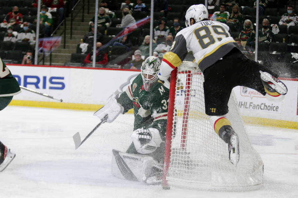 Minnesota Wild goaltender Cam Talbot (33) stops a shot by Vegas Golden Knights right wing Alex Tuch (89) during the second period in Game 6 of an NHL hockey Stanley Cup first-round playoff series Wednesday, May 26, 2021, in St. Paul, Minn. (AP Photo/Andy Clayton-King)