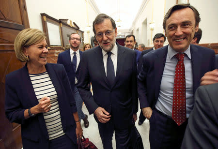 Spain's acting Prime Minister Mariano Rajoy, his ruling People's Party (PP) secretary general Maria Dolores de Cospedal and fellow deputy Rafael Hernando smile after the investiture debate at the Parliament in Madrid, Spain October 27, 2016. REUTERS/Sergio Perez