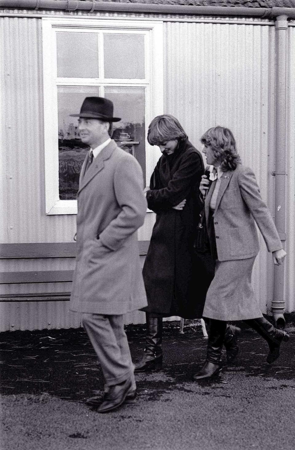 Princess Diana and Camille Parker Bowles walk together at Ludlow Racecourse in 1980.